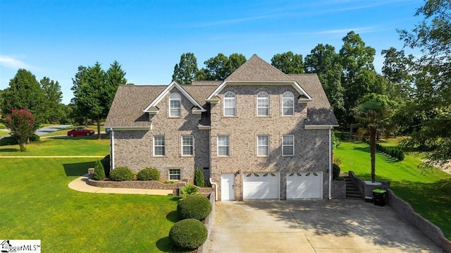 view of front of house with a front yard and a garage