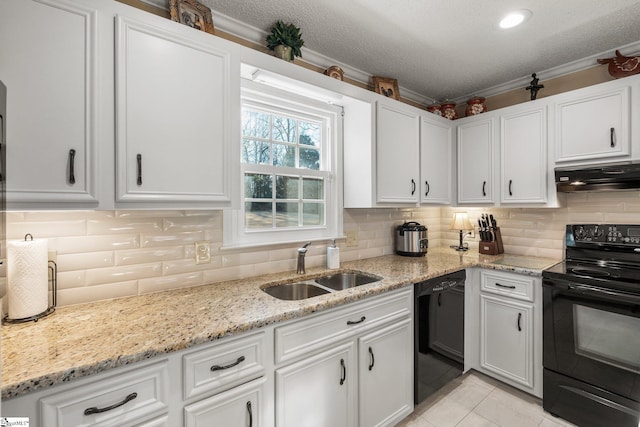 kitchen with sink, tasteful backsplash, white cabinetry, and black appliances