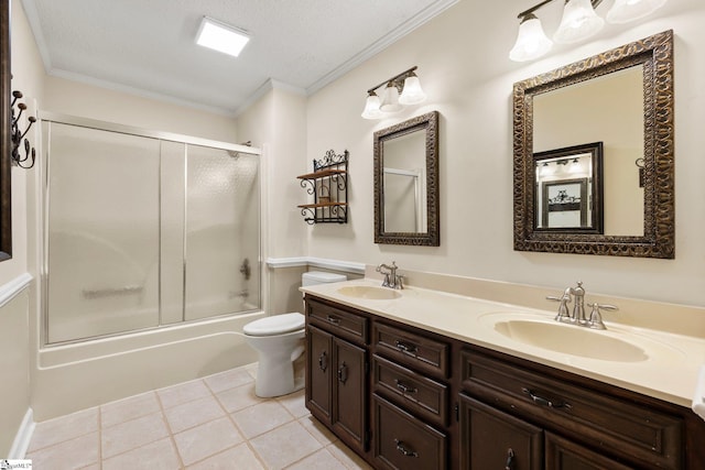 full bathroom featuring tile patterned floors, combined bath / shower with glass door, crown molding, toilet, and a textured ceiling