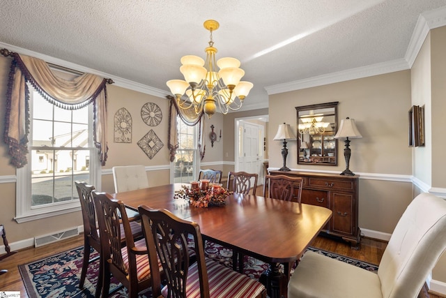 dining space featuring a wealth of natural light, crown molding, a chandelier, and hardwood / wood-style flooring