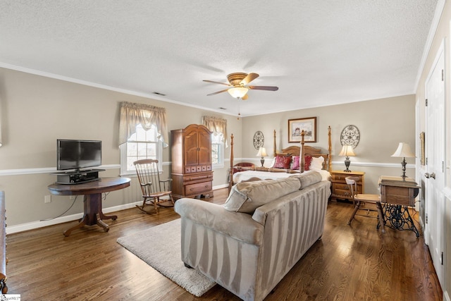 bedroom with ornamental molding, a textured ceiling, ceiling fan, and dark wood-type flooring