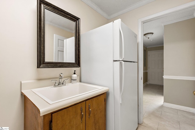 bathroom with tile patterned flooring, vanity, and crown molding