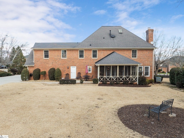 back of house with a sunroom and a patio