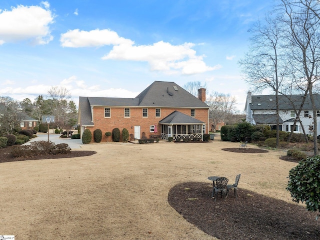 rear view of property with a sunroom