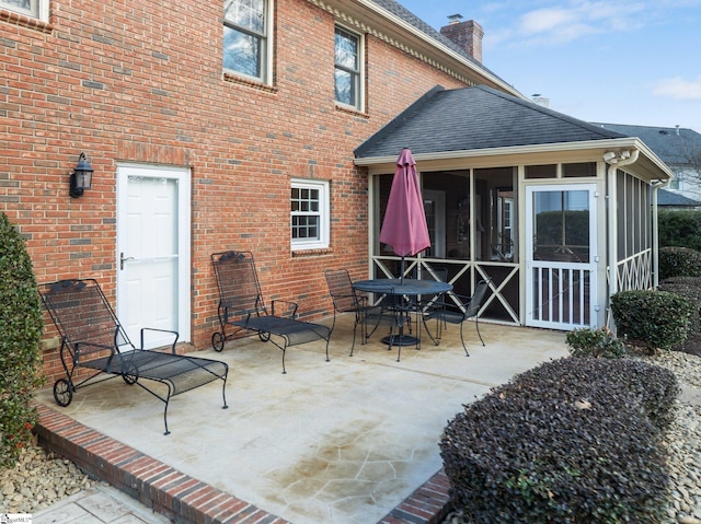 back of house featuring a sunroom