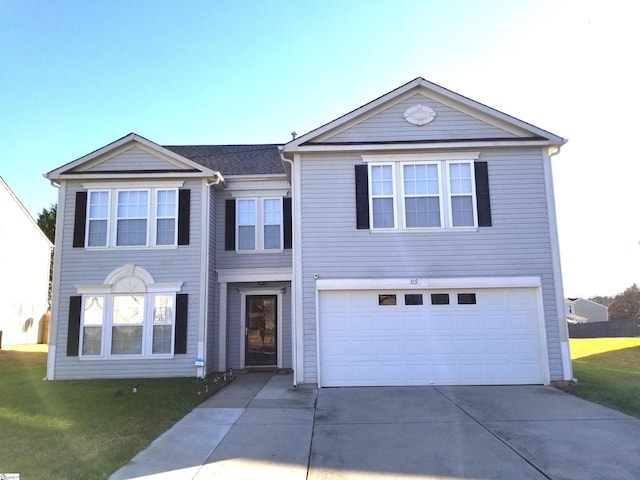 view of front of property featuring a garage and a front lawn