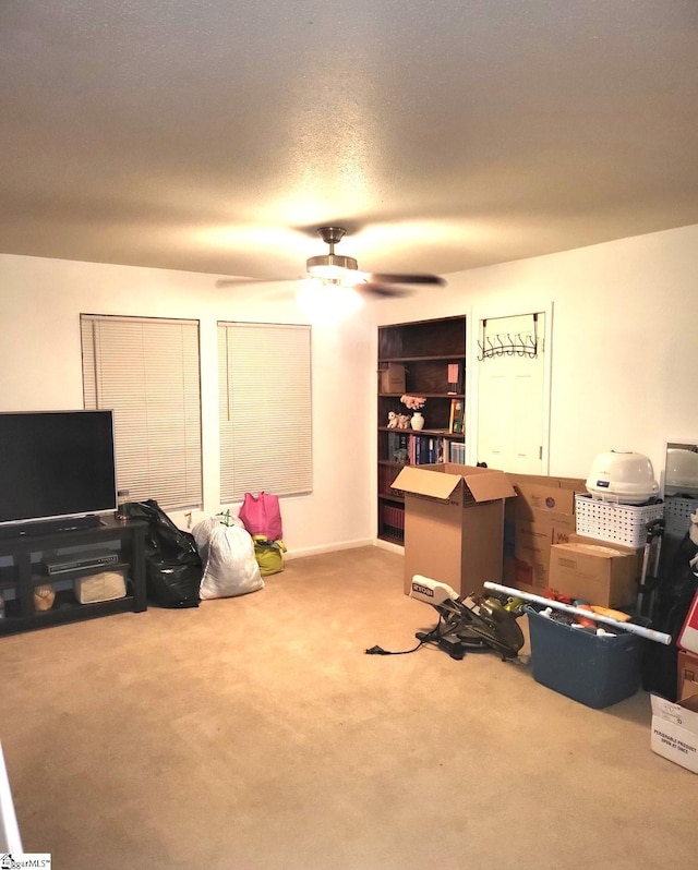 interior space with ceiling fan and a textured ceiling