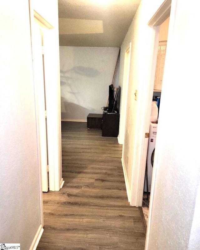 hall with washer / clothes dryer and dark hardwood / wood-style floors