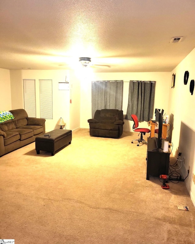 carpeted living room featuring a textured ceiling