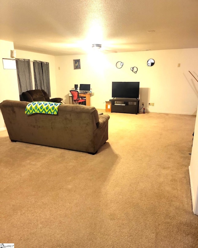 carpeted living room featuring a textured ceiling