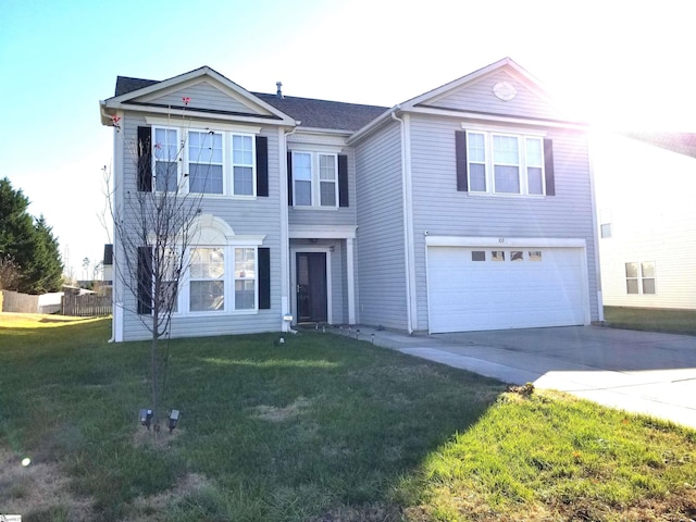 view of property featuring a garage and a front lawn