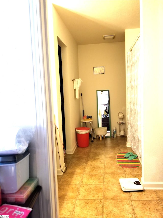 corridor featuring tile patterned flooring