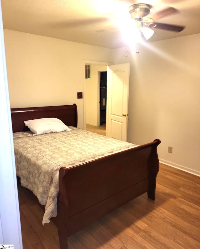 bedroom featuring hardwood / wood-style floors and ceiling fan