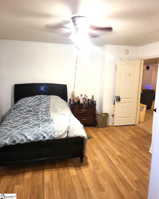 bedroom with hardwood / wood-style floors and ceiling fan