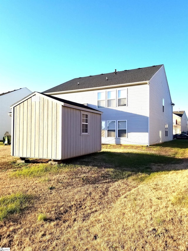 back of house with a yard