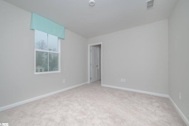 empty room featuring light colored carpet