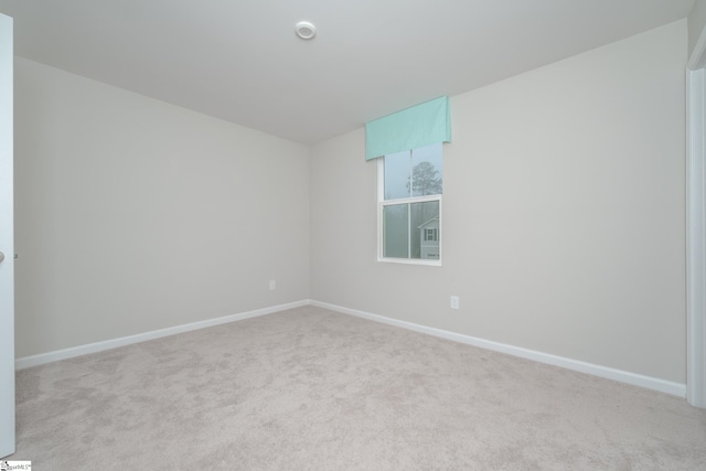 unfurnished room featuring light carpet