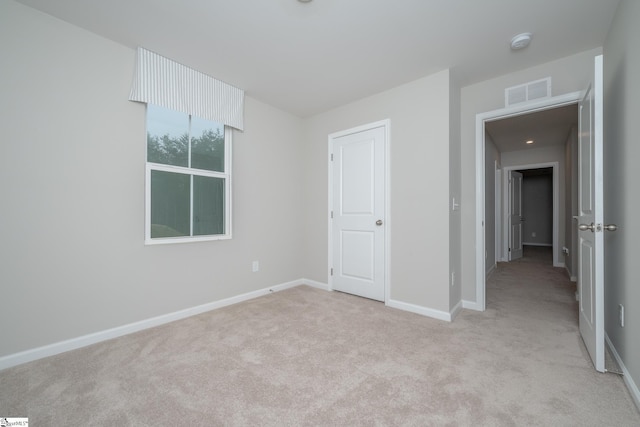 unfurnished bedroom with light carpet