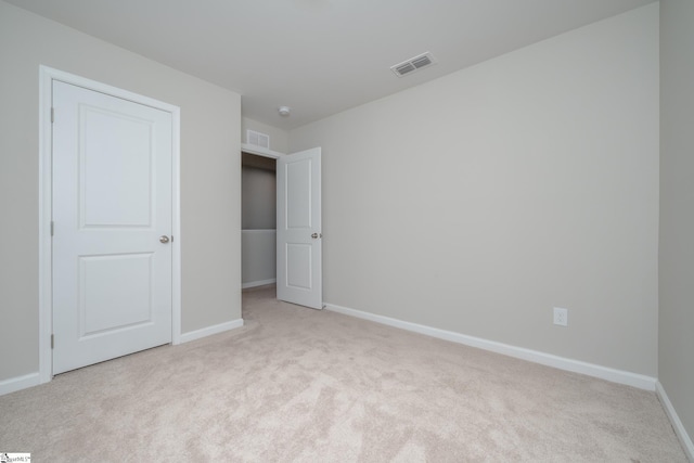 unfurnished bedroom featuring light carpet