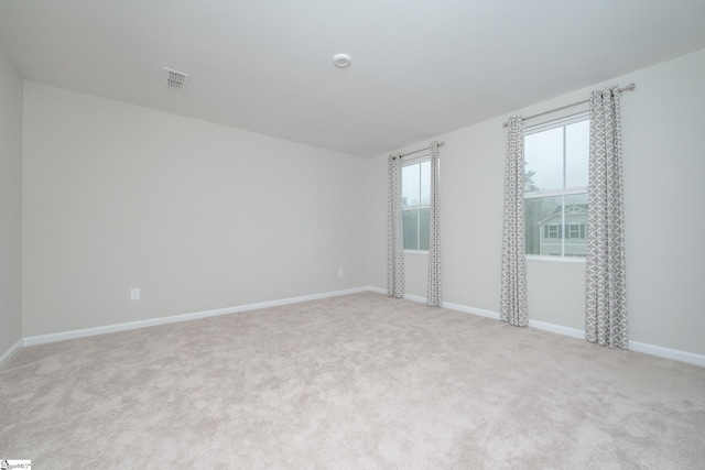 unfurnished room with light carpet