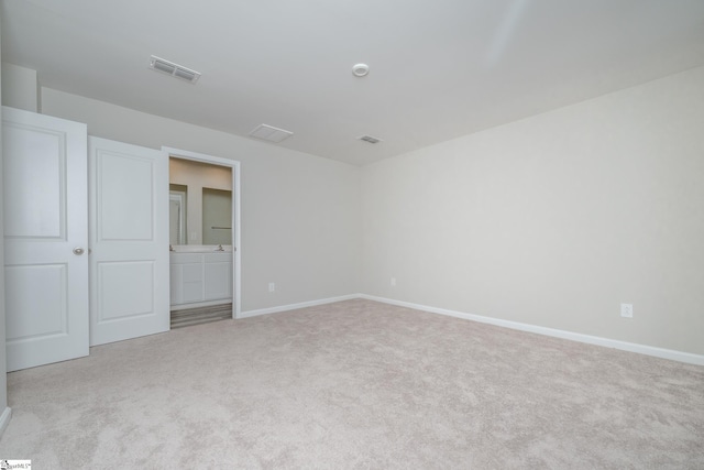 unfurnished bedroom featuring light carpet