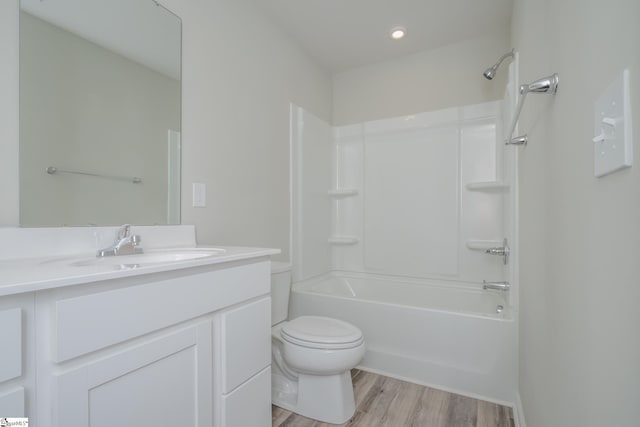 full bathroom with bathtub / shower combination, hardwood / wood-style floors, vanity, and toilet