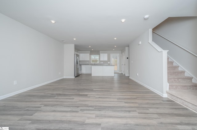 unfurnished living room featuring light wood-type flooring