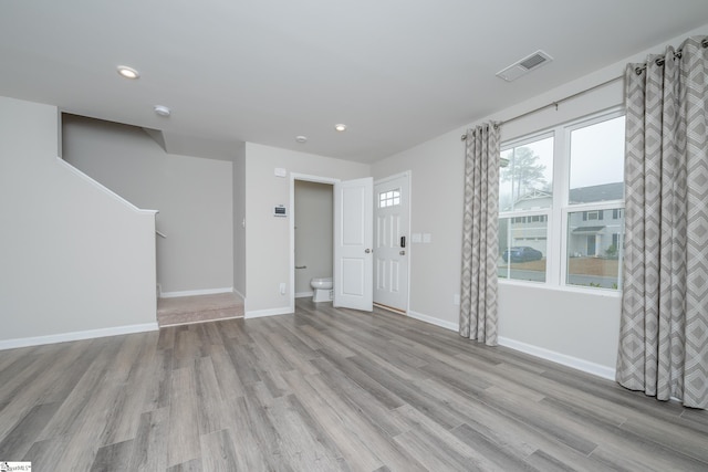 empty room with light hardwood / wood-style flooring