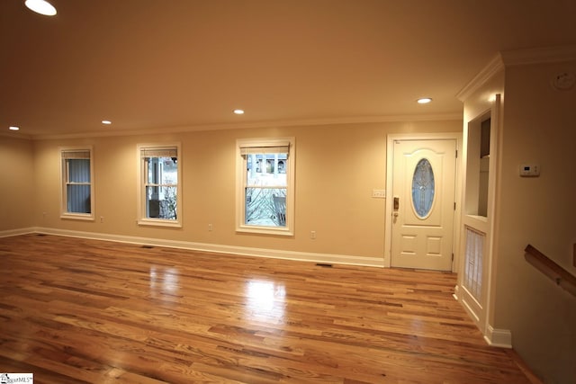 entryway featuring light hardwood / wood-style floors and ornamental molding