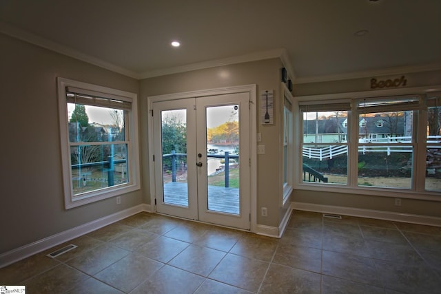 doorway with french doors, tile patterned flooring, a healthy amount of sunlight, and ornamental molding