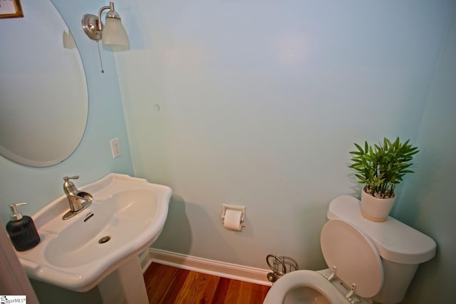 bathroom with sink, wood-type flooring, and toilet