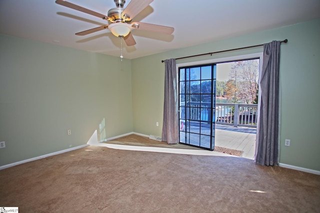 spare room with carpet and ceiling fan