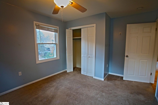 unfurnished bedroom with ceiling fan, a closet, and light carpet