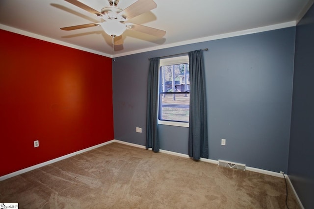 carpeted empty room featuring ceiling fan and crown molding