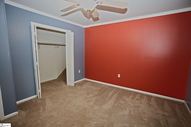 unfurnished bedroom featuring ceiling fan, ornamental molding, light carpet, and a closet