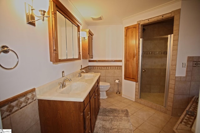 bathroom featuring walk in shower, tile patterned flooring, crown molding, vanity, and tile walls