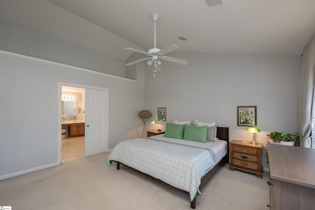 bedroom with ensuite bath, ceiling fan, light colored carpet, and lofted ceiling