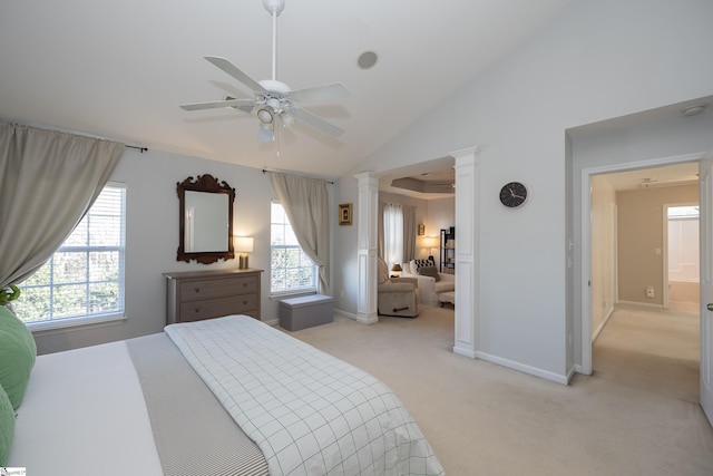 bedroom with ceiling fan, light colored carpet, ornate columns, and high vaulted ceiling