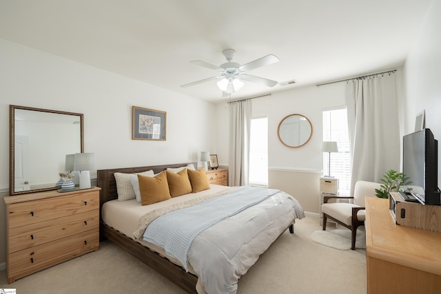 bedroom with ceiling fan and light carpet