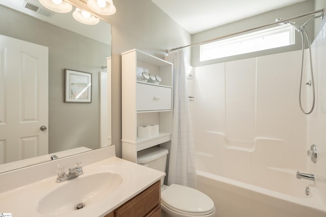 full bathroom featuring vanity, shower / bathtub combination with curtain, and toilet