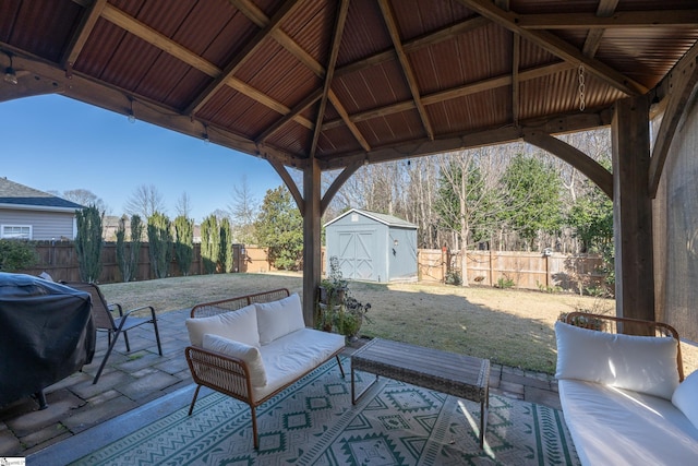 view of patio with a gazebo, an outdoor hangout area, a storage unit, and a grill