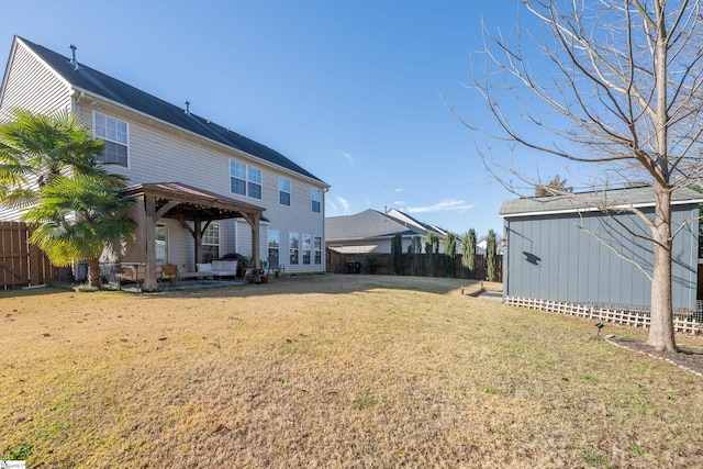 back of property with a gazebo, a shed, and a lawn