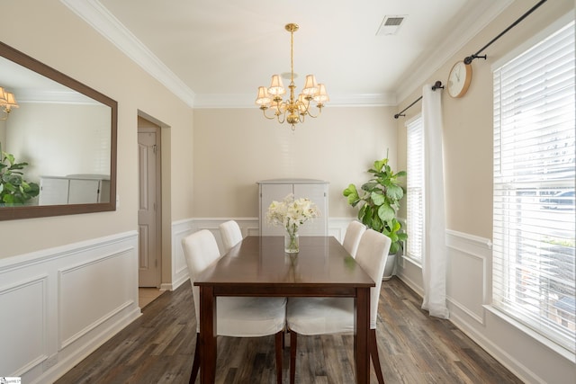 dining area with crown molding, dark hardwood / wood-style floors, and a notable chandelier