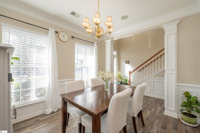 dining room featuring a chandelier, dark hardwood / wood-style flooring, plenty of natural light, and ornamental molding