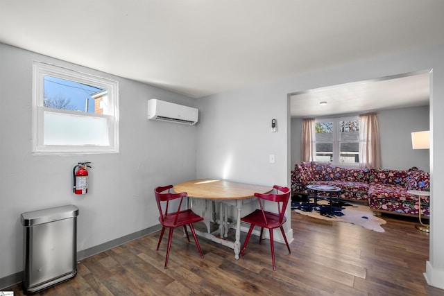 dining room featuring a wall mounted AC and dark wood-type flooring