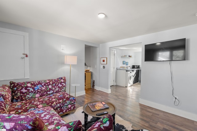 living room with hardwood / wood-style flooring and washer / clothes dryer