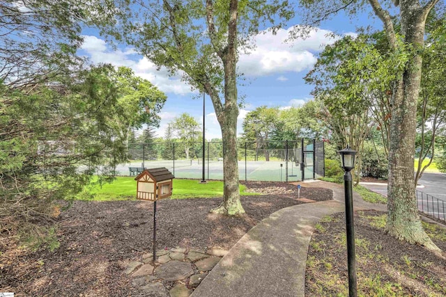 view of property's community featuring fence and a gate