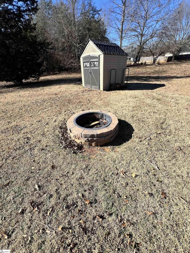 view of yard with a fire pit and a storage unit