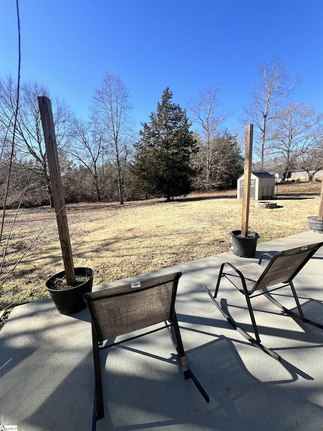 view of patio / terrace with a shed