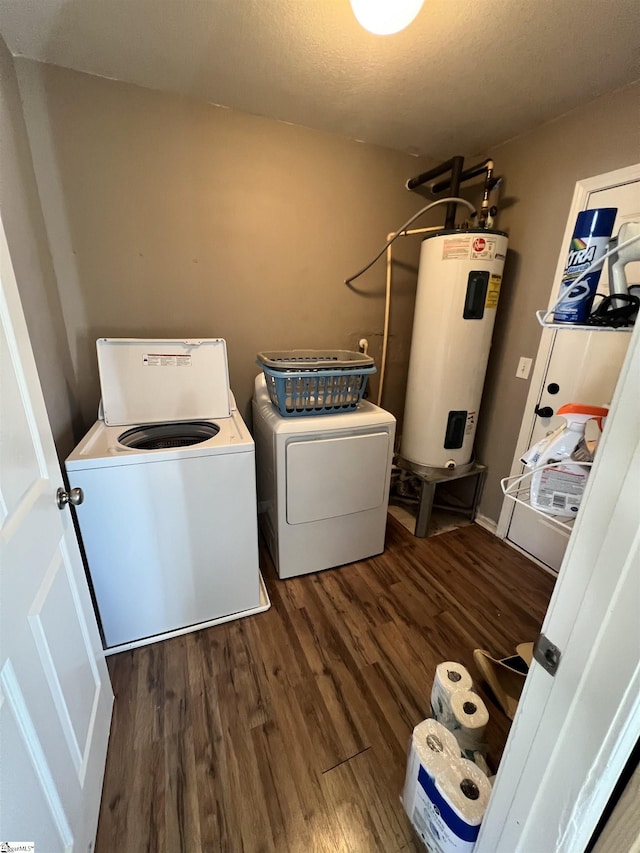 laundry area featuring washer and clothes dryer, water heater, and dark hardwood / wood-style flooring